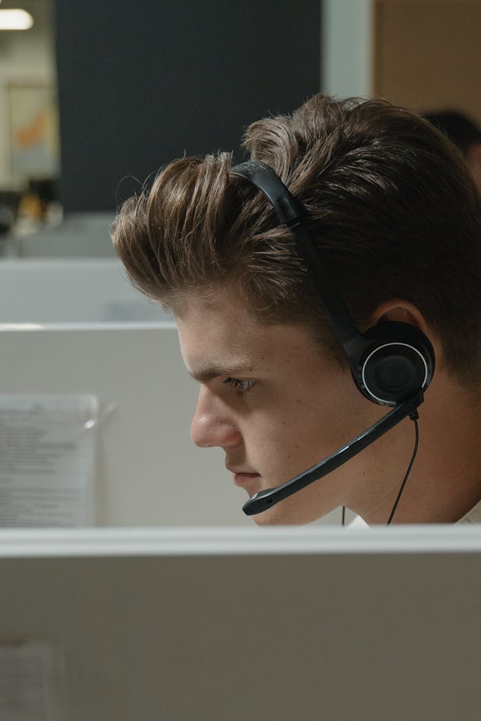 A Man Wearing Black Headphones while Working